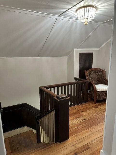 bonus room featuring lofted ceiling and light wood-style floors