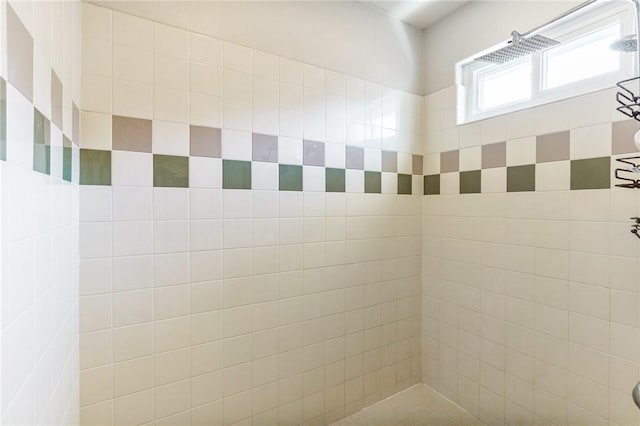 interior details with a tile shower