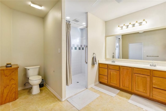 full bathroom featuring toilet, a sink, baseboards, tiled shower, and double vanity