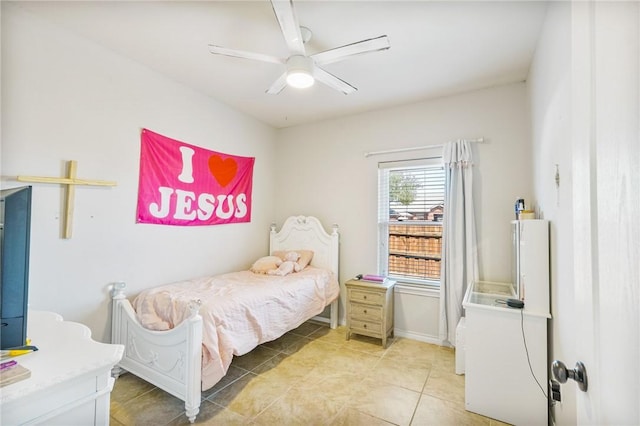 bedroom with light tile patterned flooring, a ceiling fan, and baseboards