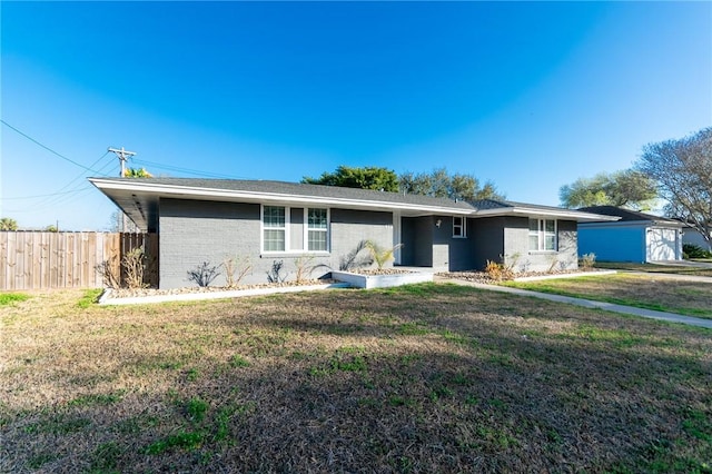 single story home with brick siding, a front lawn, and fence