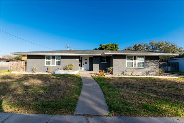 ranch-style home featuring a front yard and fence