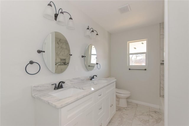 bathroom featuring a sink, baseboards, toilet, and marble finish floor