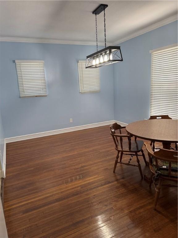 1101 N Adams St N, Beeville, TX 78102 - dining room featuring dark wood-type flooring, baseboards, and ornamental molding