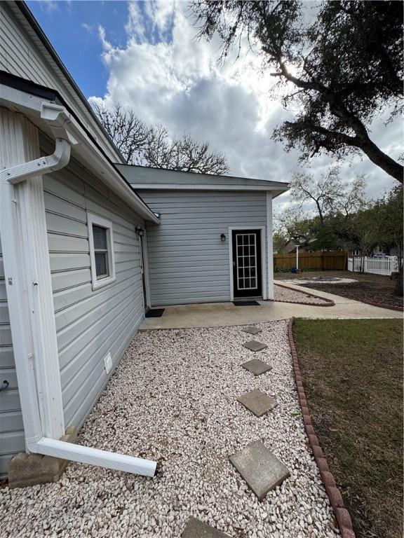 1101 N Adams St N, Beeville, TX 78102 - property entrance featuring a patio and fence