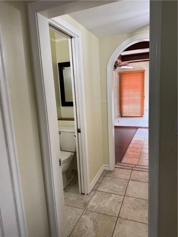 1101 N Adams St N, Beeville, TX 78102 - hallway with arched walkways, light tile patterned flooring, and baseboards