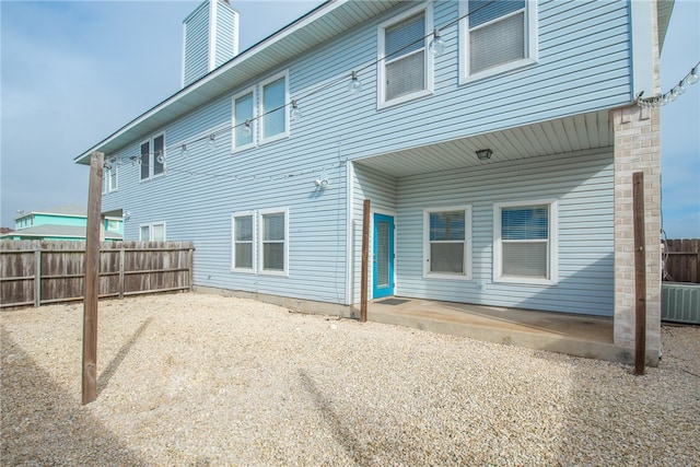 rear view of house with cooling unit and a patio area