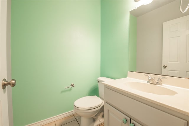 bathroom with vanity, tile patterned flooring, and toilet