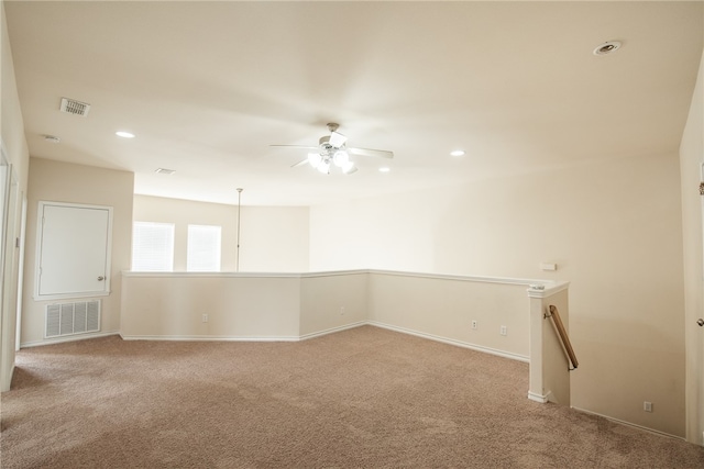 carpeted empty room featuring ceiling fan