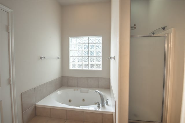 bathroom featuring shower with separate bathtub