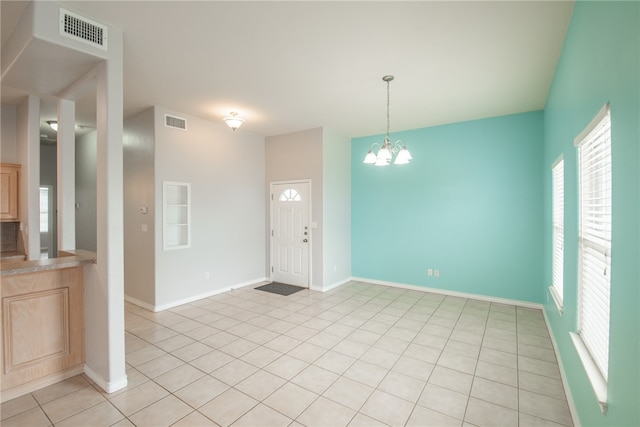 entrance foyer featuring a chandelier and light tile patterned floors