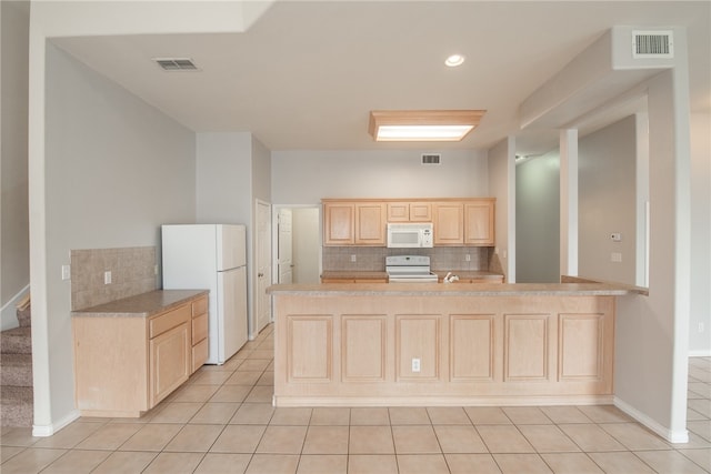 kitchen with kitchen peninsula, light brown cabinetry, light tile patterned floors, backsplash, and white appliances