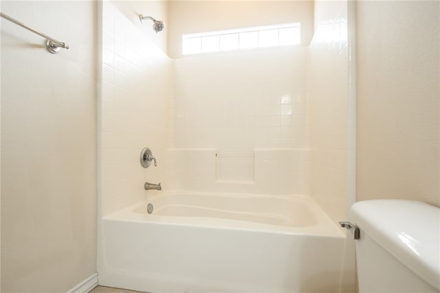 bathroom with toilet and  shower combination