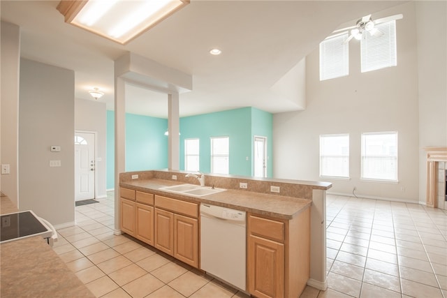 kitchen with dishwasher, a wealth of natural light, sink, and light tile patterned floors