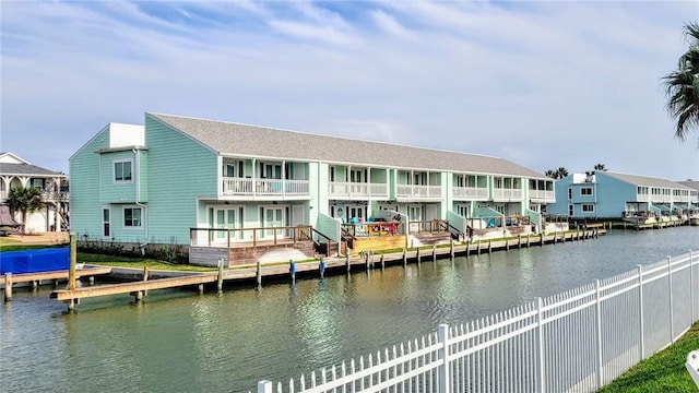 rear view of property with a water view