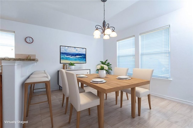 dining room with baseboards and an inviting chandelier