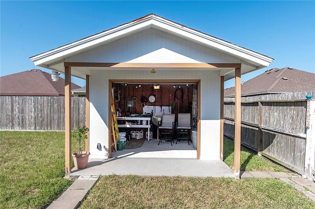 view of patio / terrace featuring a garage and fence