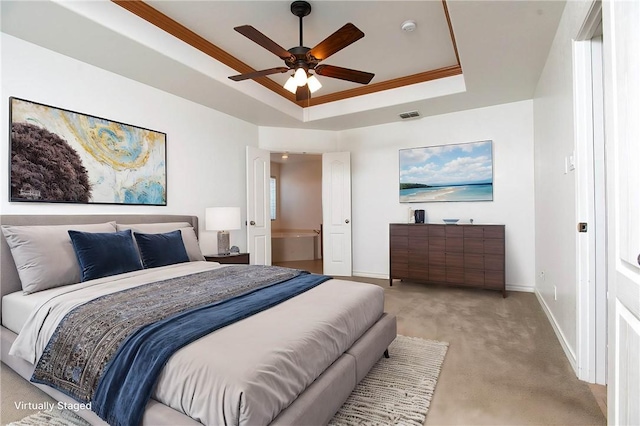 bedroom featuring visible vents, baseboards, ornamental molding, light carpet, and a raised ceiling