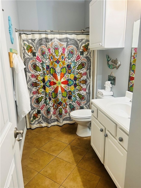 bathroom with vanity, tile patterned floors, and toilet