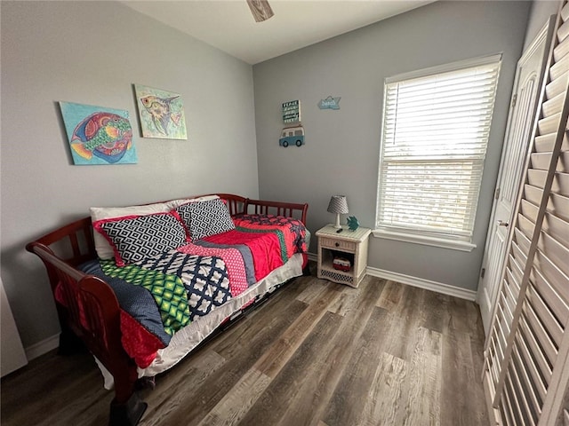 bedroom featuring multiple windows, wood-type flooring, and ceiling fan