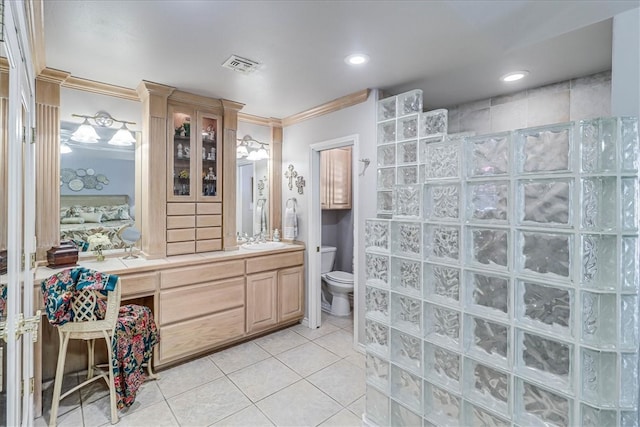 bathroom with ornamental molding, walk in shower, vanity, tile patterned flooring, and toilet