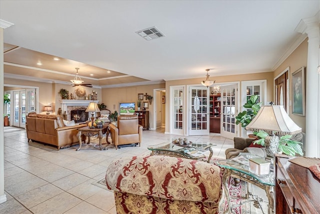 living room featuring french doors, light tile patterned floors, and crown molding