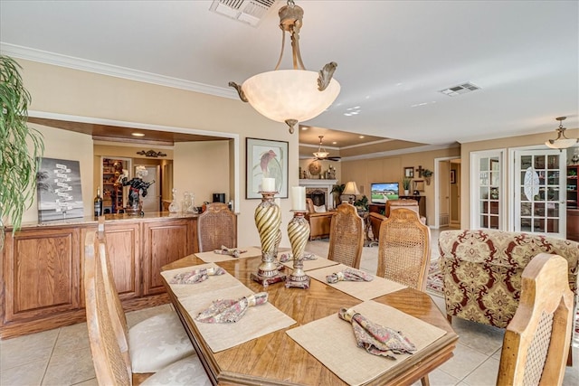 dining room with ornamental molding and light tile patterned floors