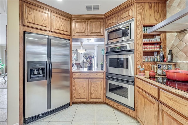 kitchen with stainless steel appliances, light tile patterned flooring, and tasteful backsplash