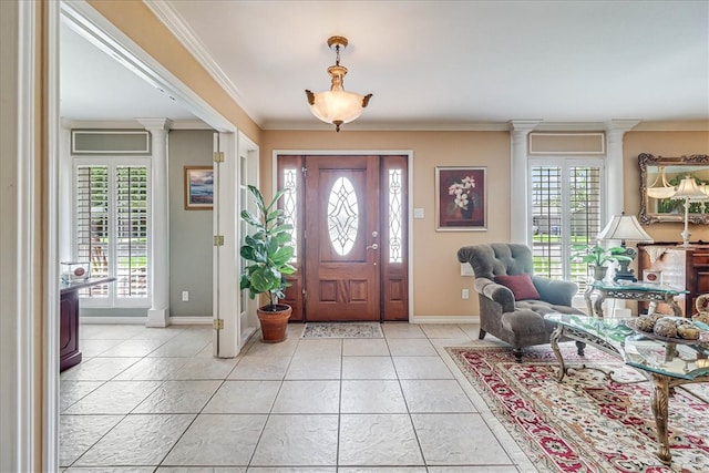 entrance foyer featuring decorative columns, light tile patterned floors, and crown molding