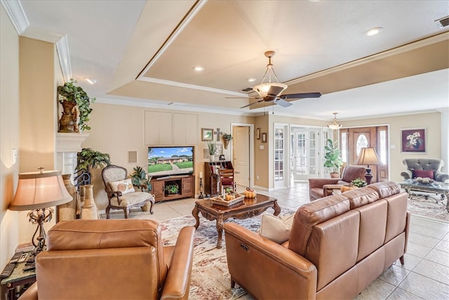 tiled living room featuring ornamental molding and ceiling fan with notable chandelier