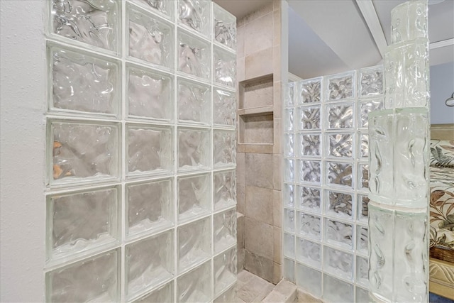 bathroom with a tile shower