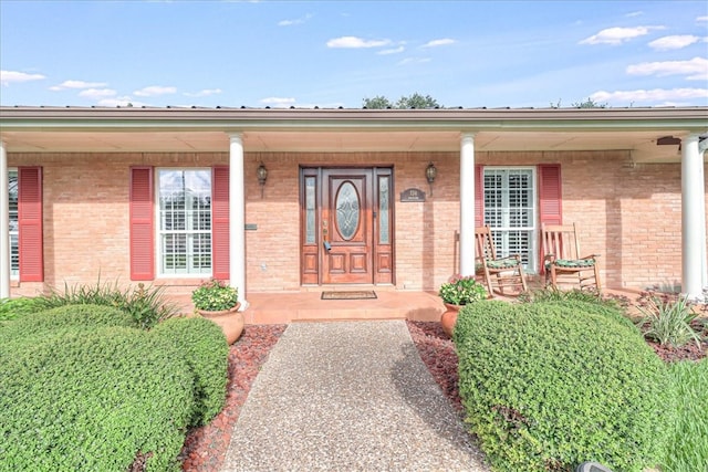 view of exterior entry with a porch