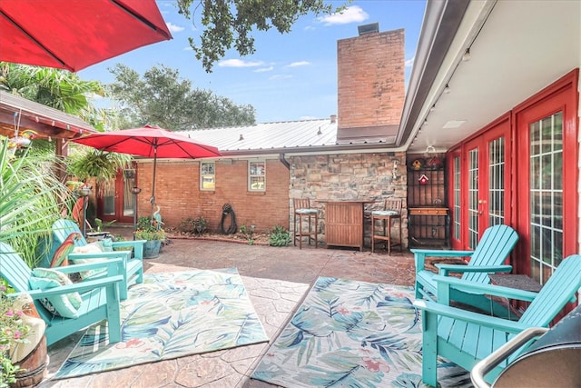 view of patio / terrace featuring exterior bar and french doors