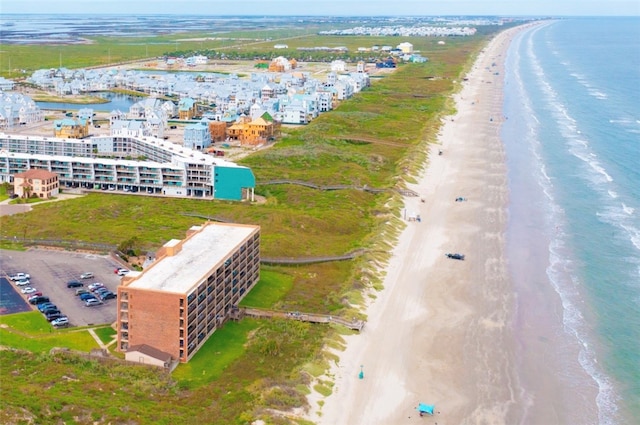 bird's eye view featuring a water view and a beach view