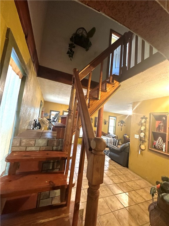 stairway featuring tile patterned flooring