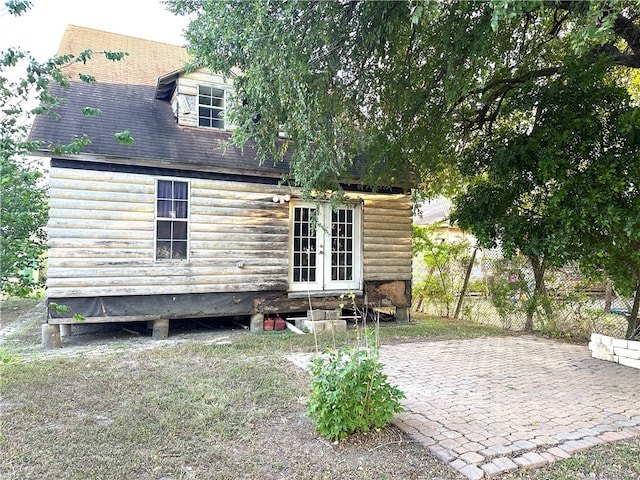 rear view of house with french doors and a patio area