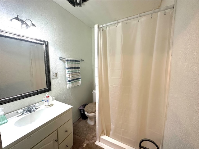 bathroom with vanity, tile patterned floors, and toilet