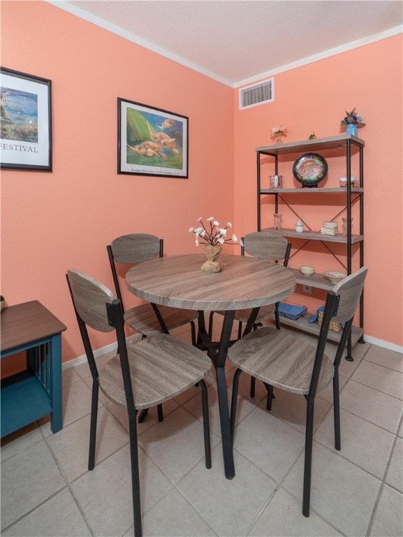 tiled dining room with crown molding