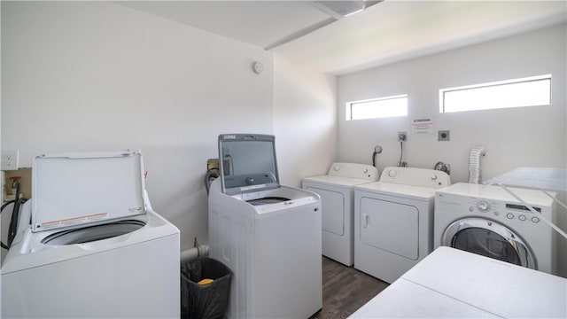 washroom with washing machine and clothes dryer and dark hardwood / wood-style flooring