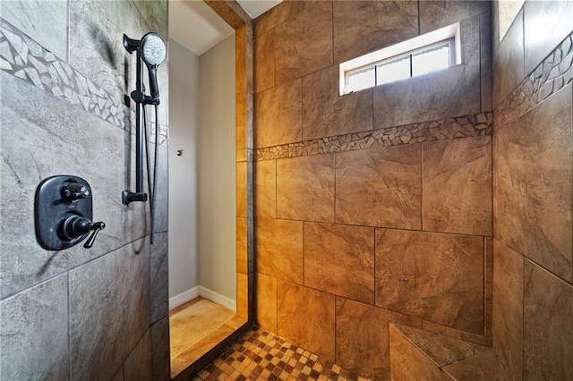 bathroom featuring a tile shower and tile patterned floors