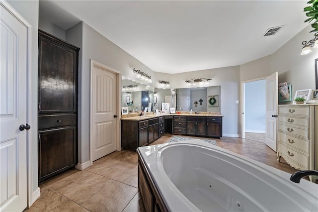 bathroom featuring tile patterned flooring, vanity, and a bathtub