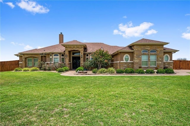 mediterranean / spanish-style home with a front lawn