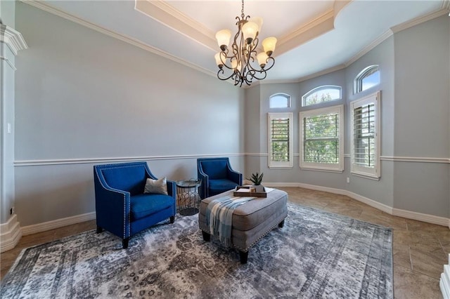 living area with crown molding, a tray ceiling, and an inviting chandelier