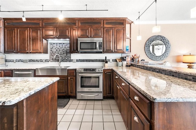 kitchen featuring light tile patterned floors, decorative backsplash, a peninsula, stainless steel appliances, and a sink