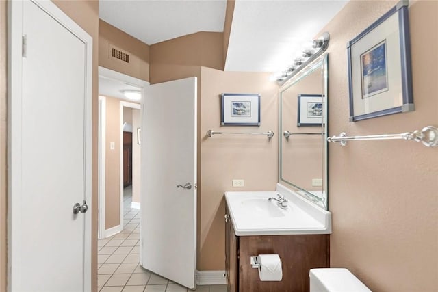 bathroom with vanity, baseboards, visible vents, tile patterned floors, and toilet