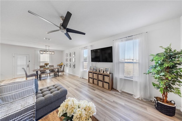 13246 Lorena Ochoa, San Antonio, TX 78221 - living room with wood finished floors, ceiling fan, and baseboards