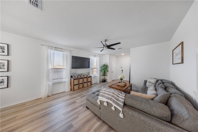 living room featuring ceiling fan and light hardwood / wood-style flooring