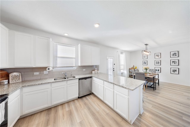 kitchen with dishwasher, light wood-type flooring, kitchen peninsula, and white cabinets