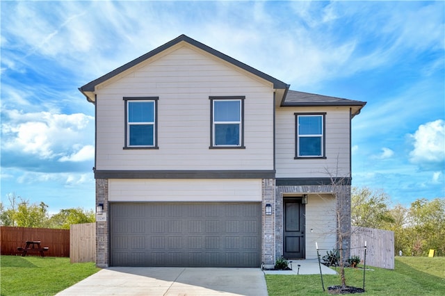 view of front of home with a garage and a front lawn