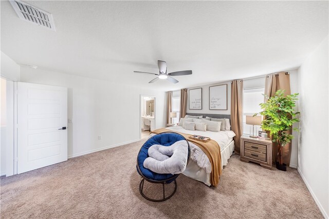 carpeted bedroom featuring connected bathroom and ceiling fan